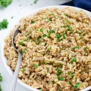 Two bowls with Cajun rice simmered on the stove top.