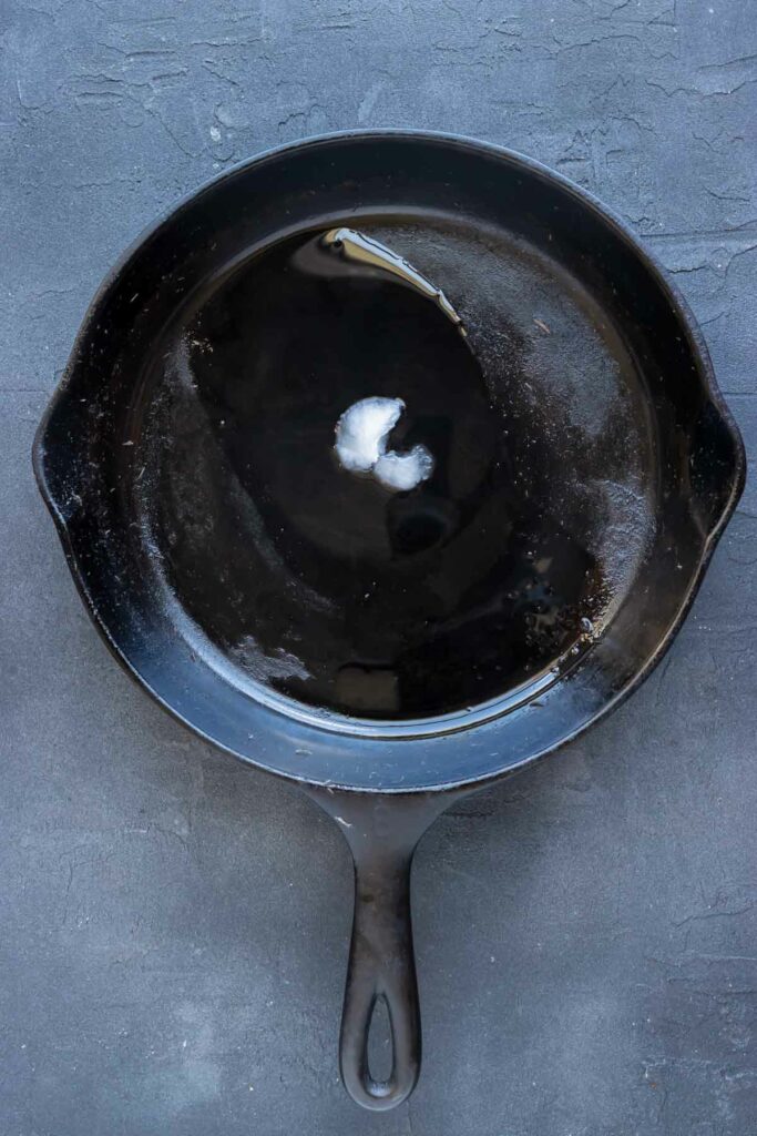Coconut oil is added to a pan before cooking plantains.