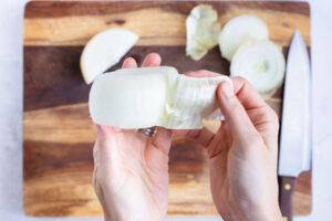 The skin is removed from the onion half.