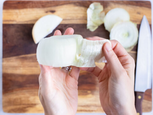 The skin is removed from the onion half.