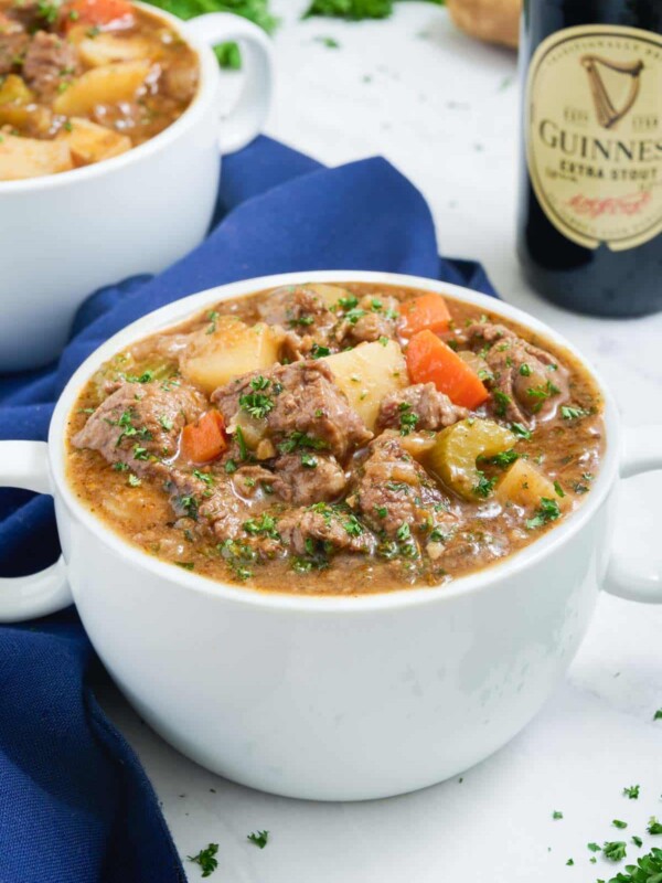 A white bowl is loaded with healthy beef stew.