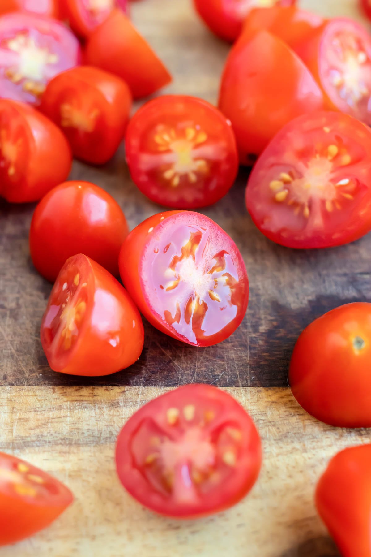 A close-up of grape tomatoes that have been cut in half.