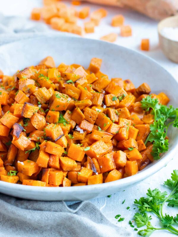 Easy, gluten-free oven roasted sweet potato cubes in a gray bowl.