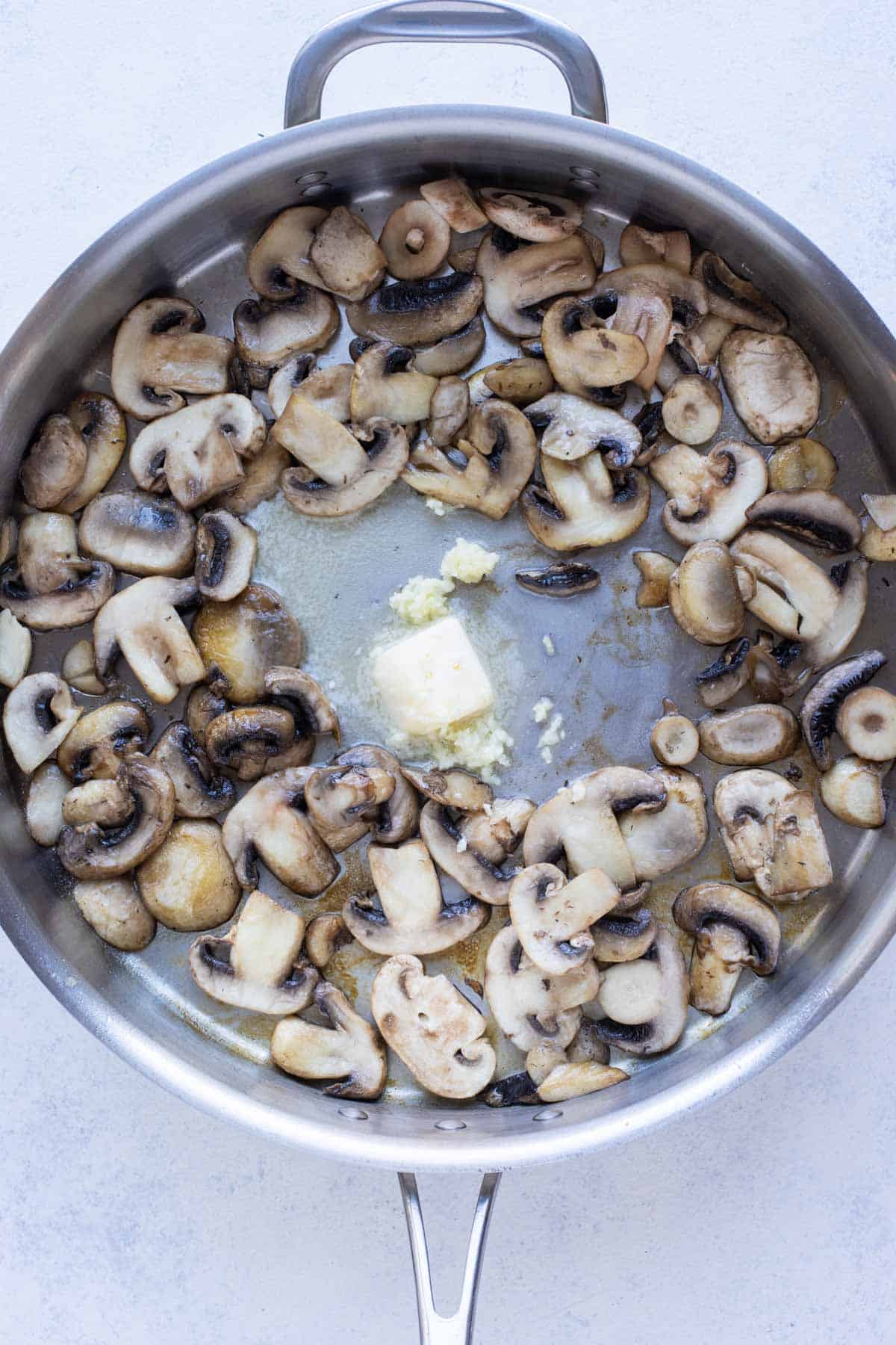 A well is made for butter and garlic.
