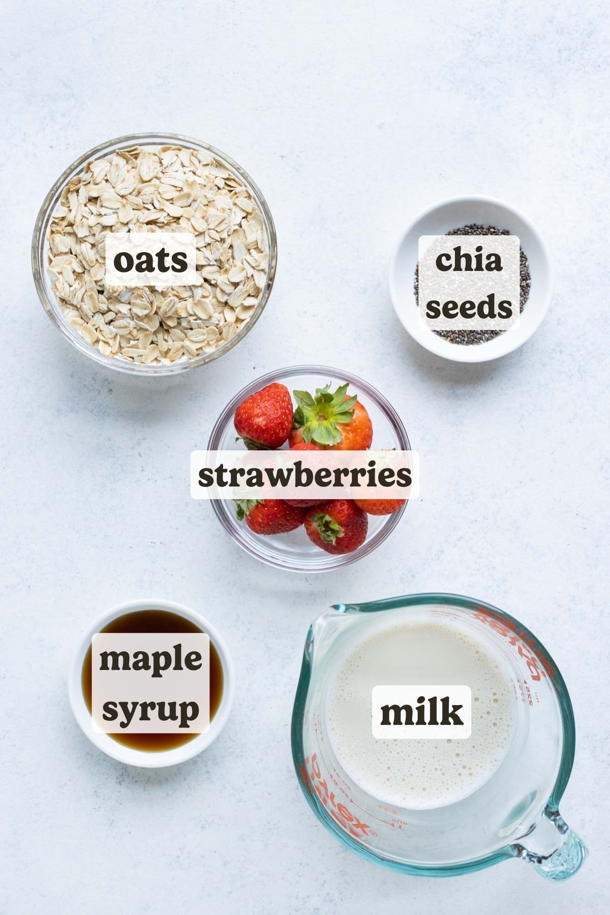 Rolled oats, strawberries, sweetener, milk, and chia seeds are the basic ingredients for this overnight oats recipe.