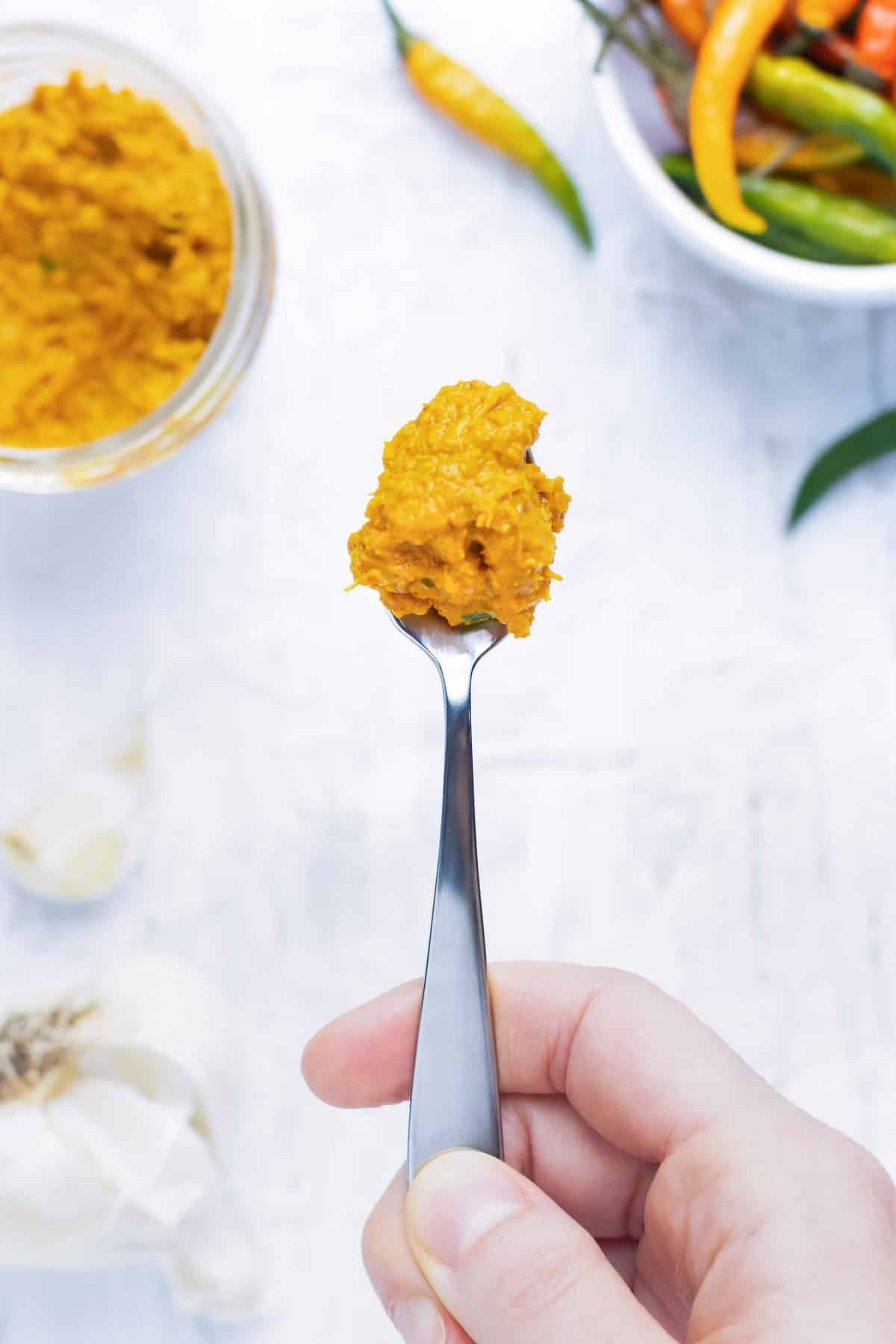 A spoon of yellow curry paste.