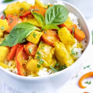 A large serving bowl full of Thai yellow curry recipe with chicken and potatoes.