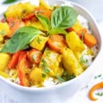 A large serving bowl full of Thai yellow curry recipe with chicken and potatoes.