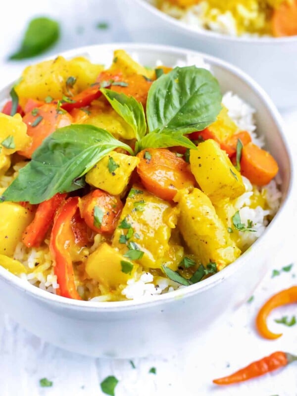 A large serving bowl full of Thai yellow curry recipe with chicken and potatoes.