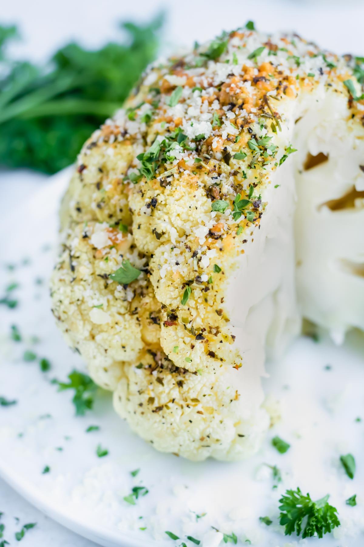 This vegan whole roasted cauliflower is baked in the oven for a low-carb and keto recipe.