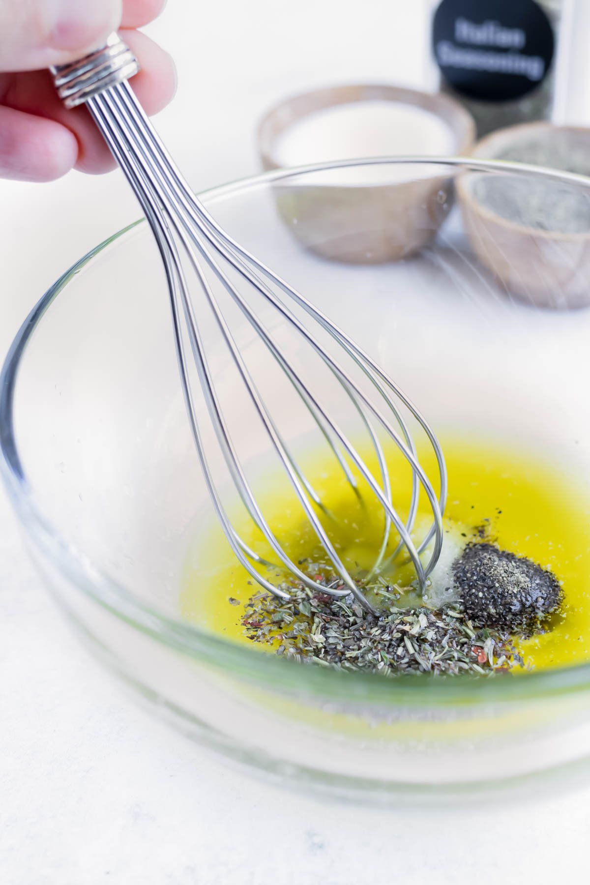 Mix melted butter, herbs, salt, pepper, and garlic in a bowl for a baked cauliflower head recipe.