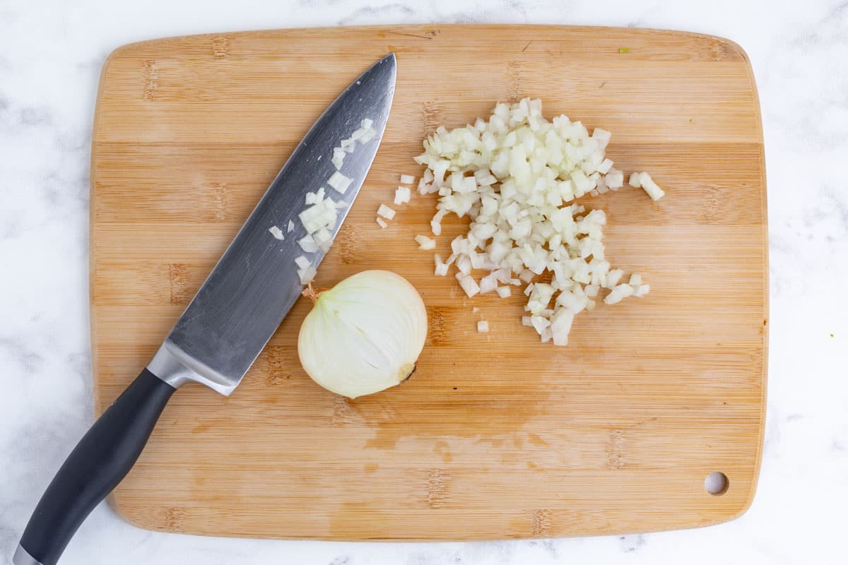 Onion is chopped on a cutting board.