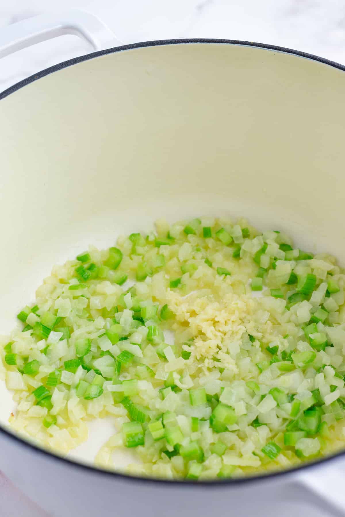 Garlic is added to the onion and celery.