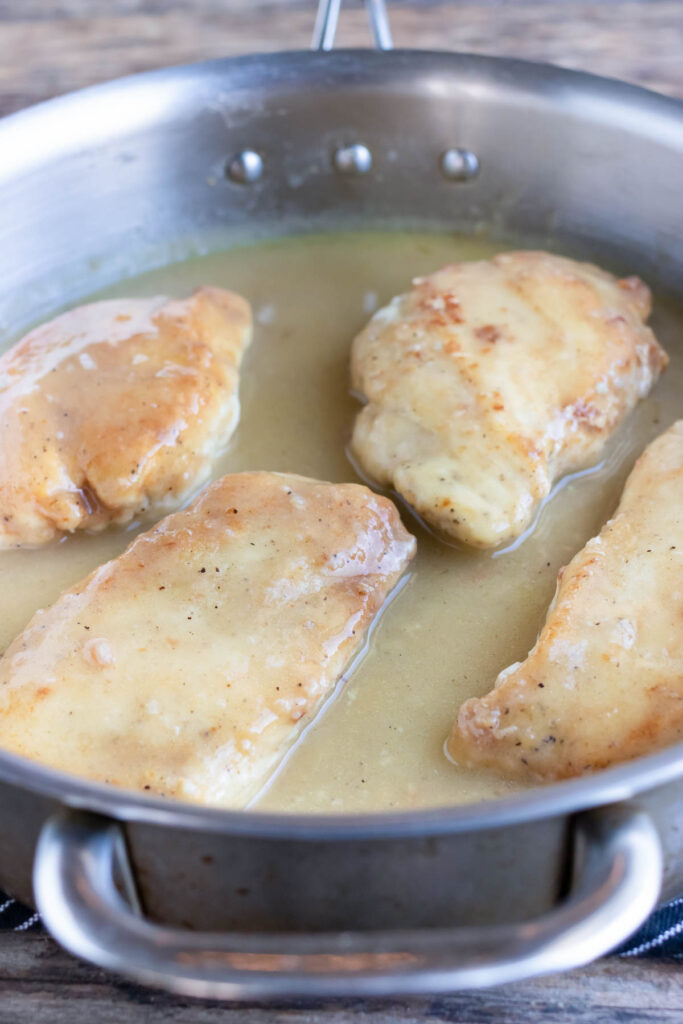 Chicken breasts are added back into the piccata sauce.