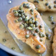 Easy Chicken Piccata with capers and a creamy lemon butter sauce in a skillet.