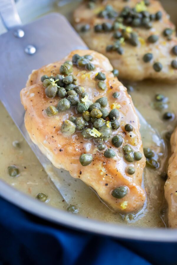 Easy Chicken Piccata with capers and a creamy lemon butter sauce in a skillet.