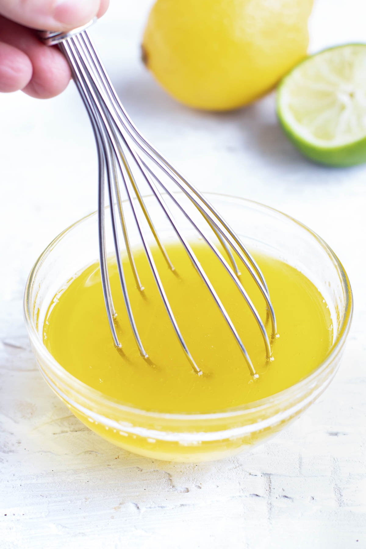 Whisking together a lemon salad dressing for a kale salad.