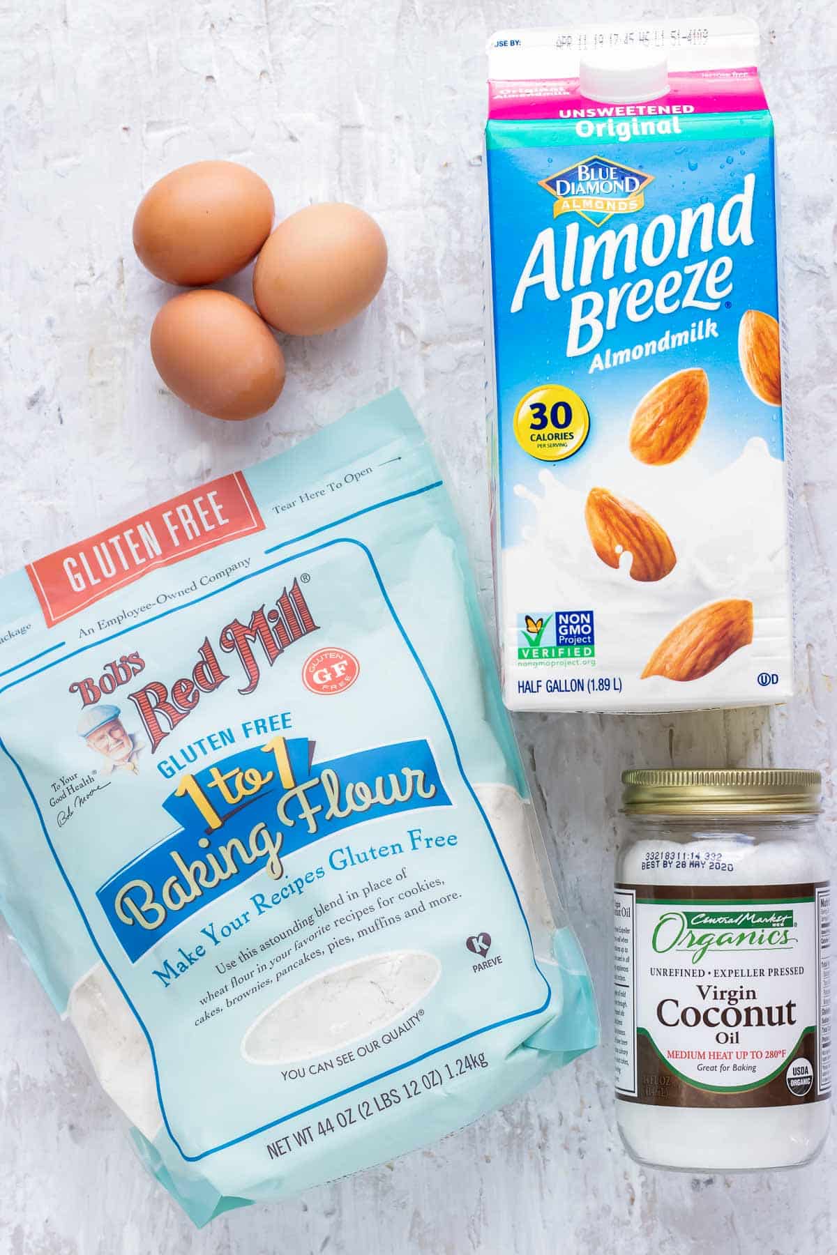 Almond milk, coconut oil, gluten-free flour, and three eggs as the ingredients for an easy pancake recipe.