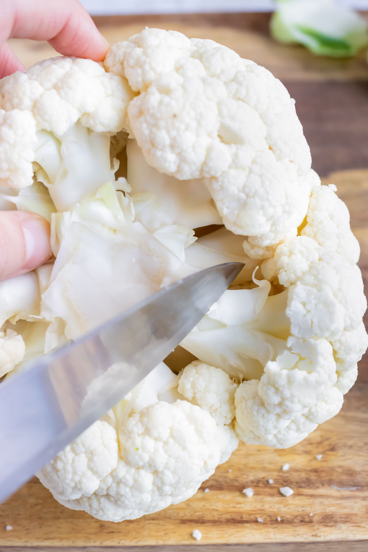 Removing the cauliflower stem from the head.