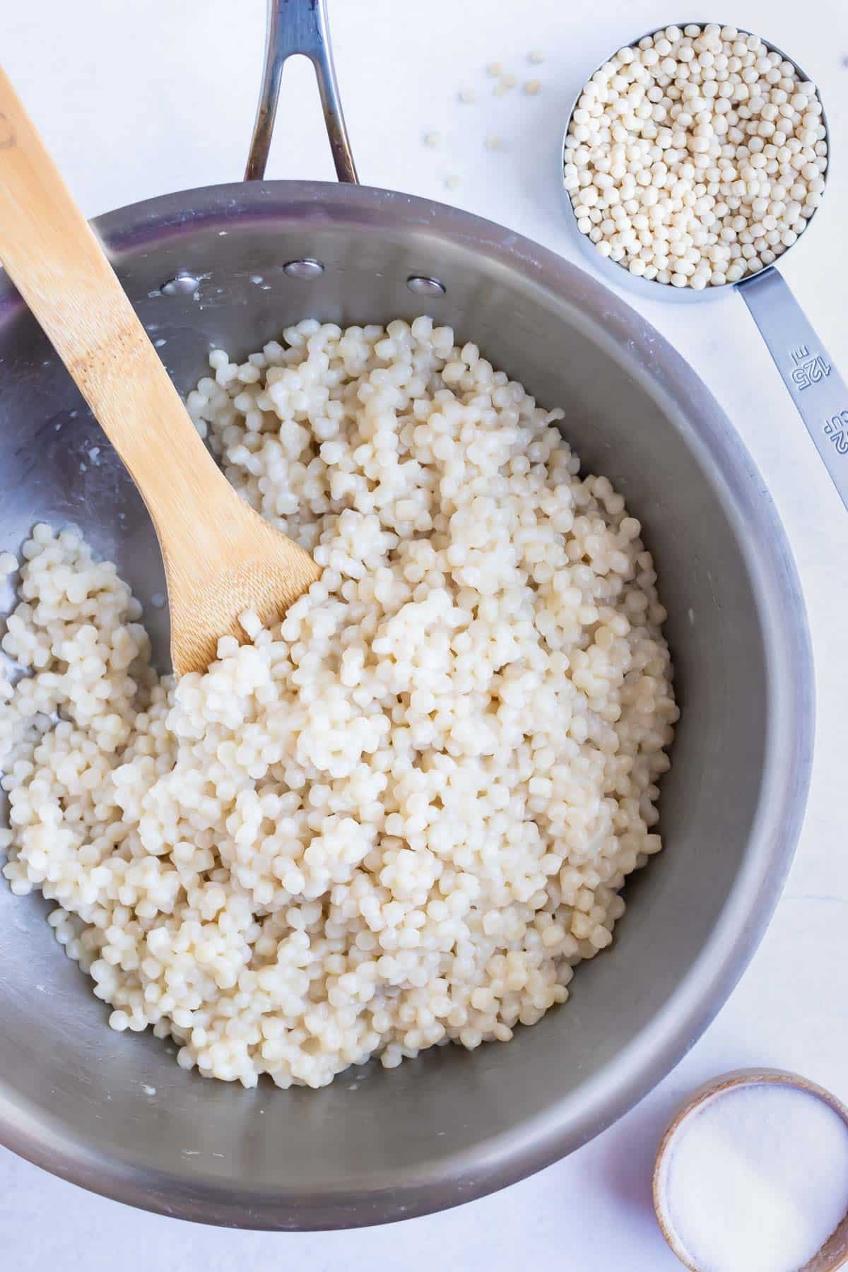 Israeli couscous cooks on the stovetop.