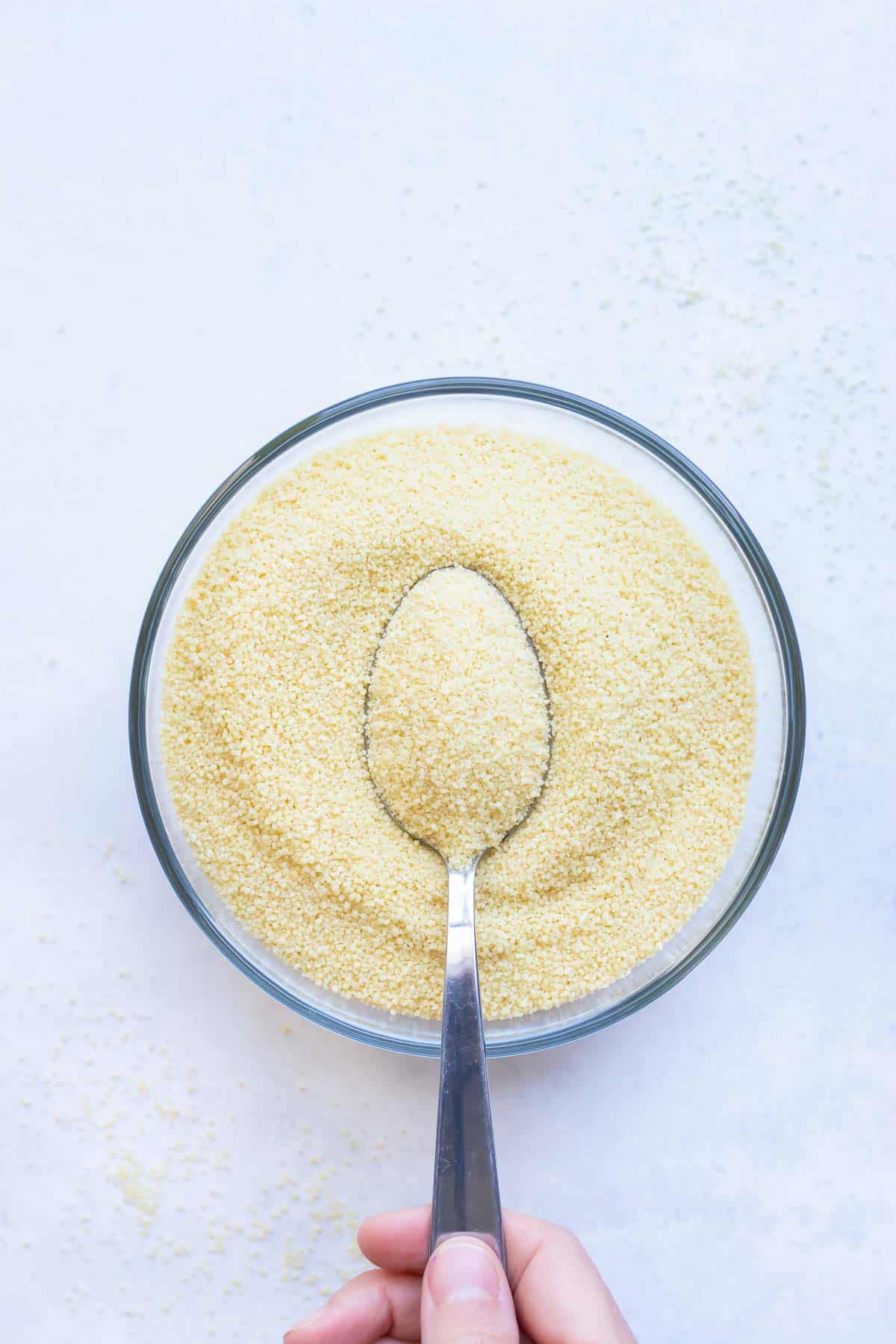 A bowl with instant couscous is ready to cook.