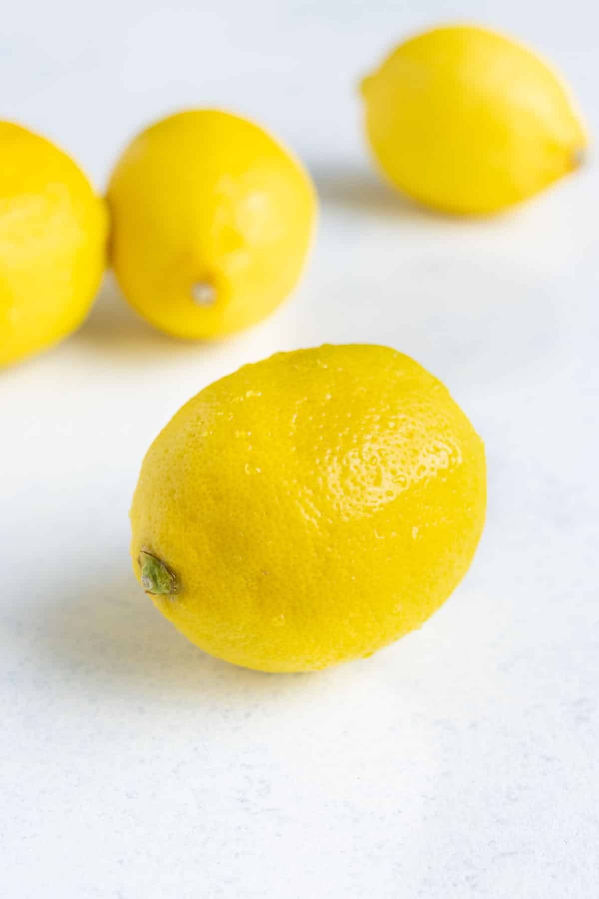 Four lemons on the countertop.