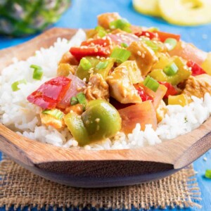 Easy 30-minute chicken dinner recipe in a wooden bowl with rice.