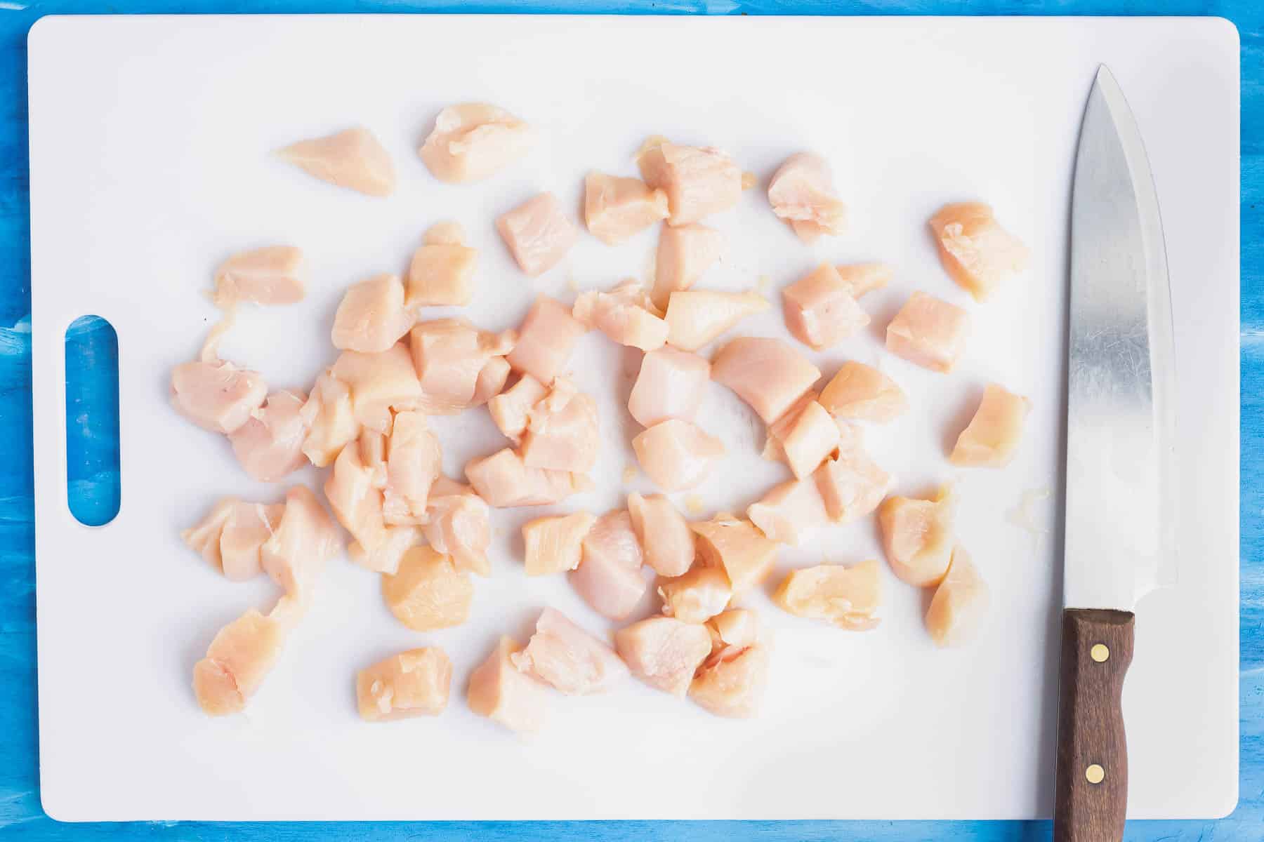 Chicken is cut into chunks.
