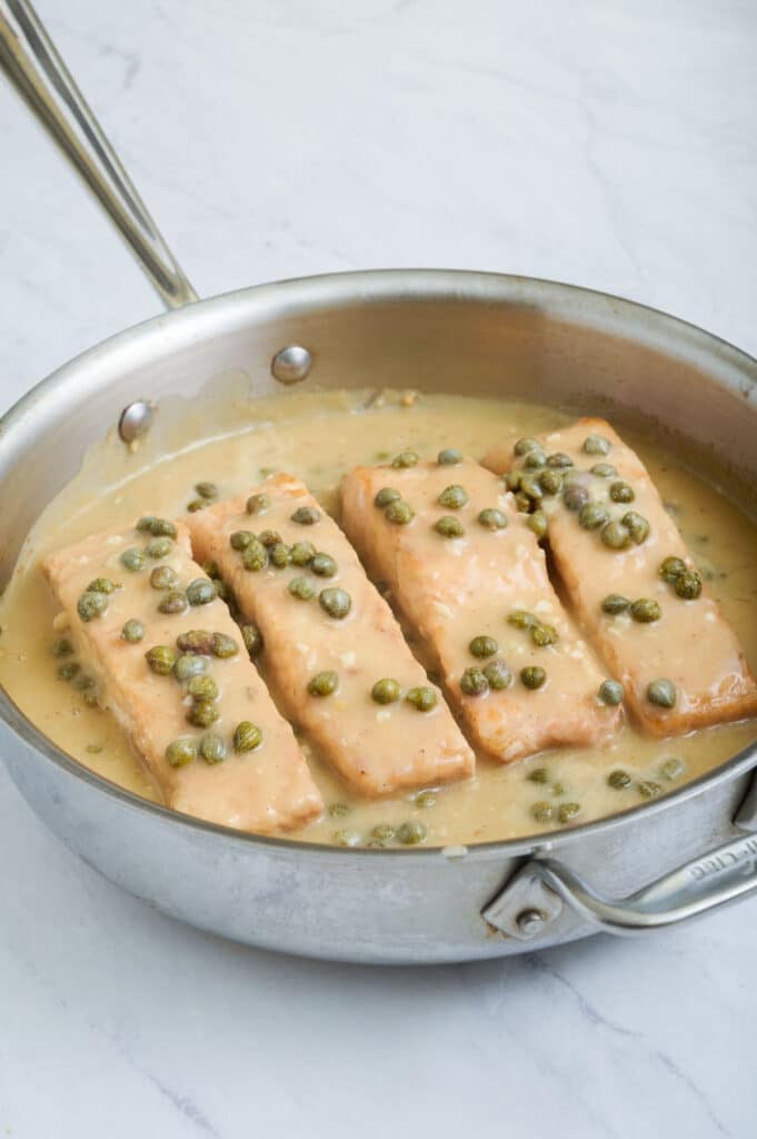 Salmon and capers are added to the sauce.