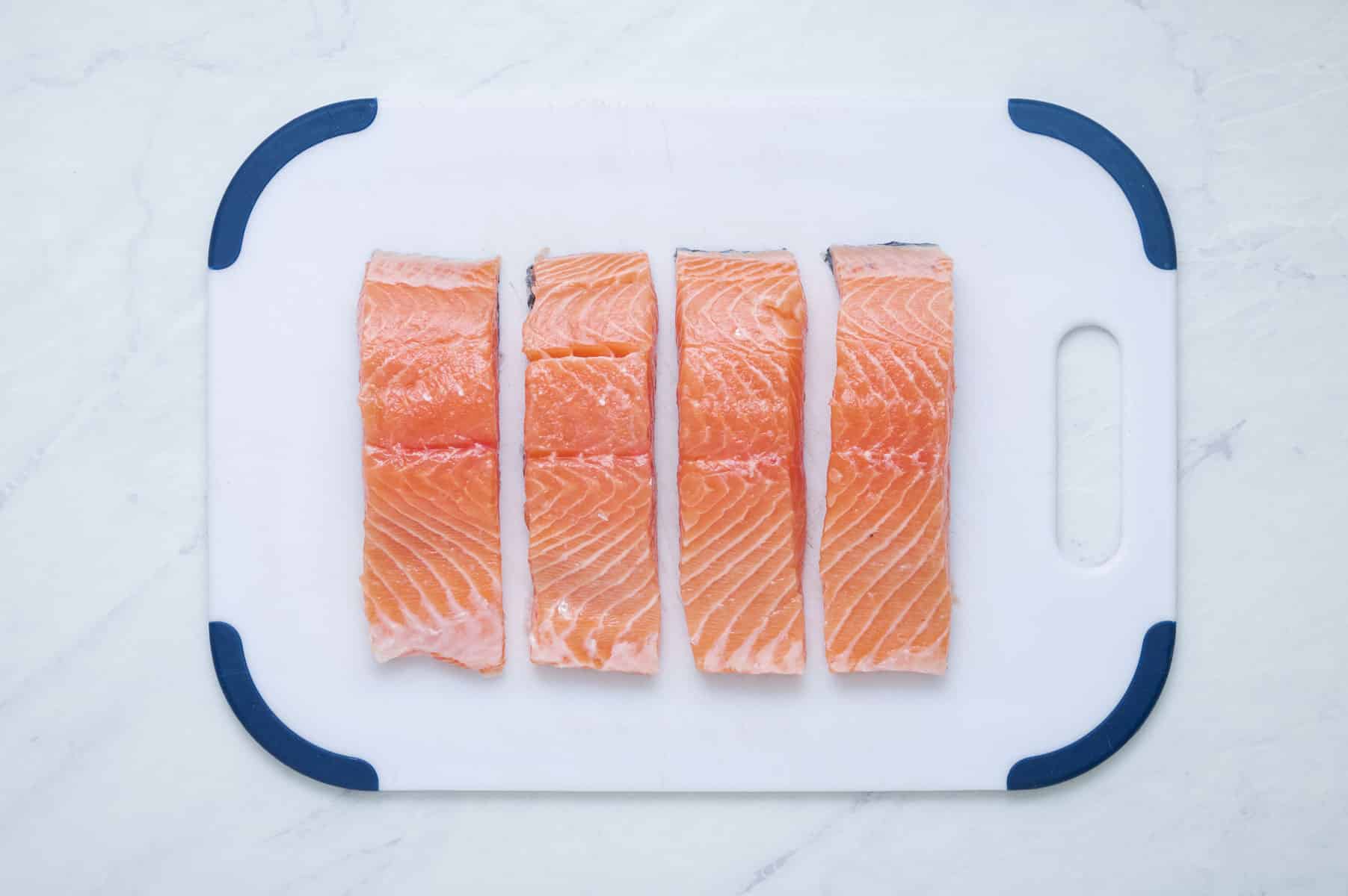 Sliced salmon on a cutting board.