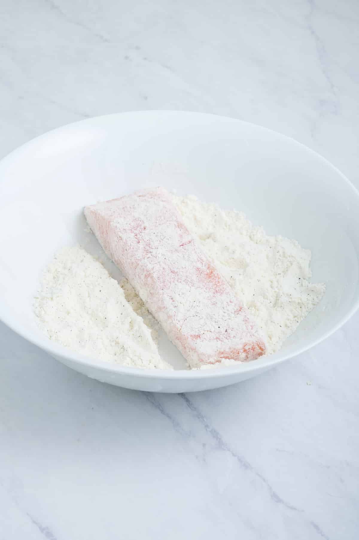 Salmon is dredged in flour.