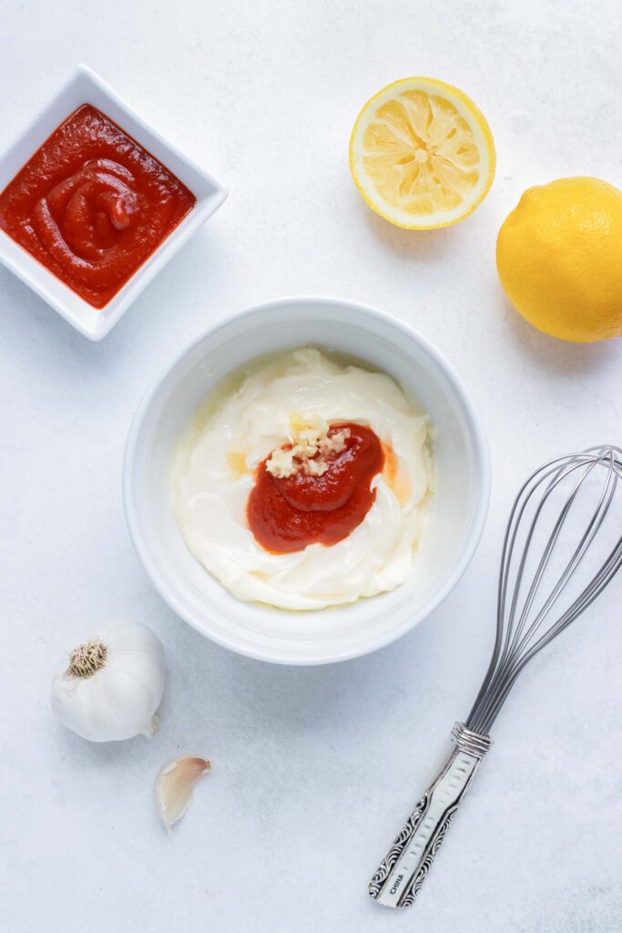 Whisk together garlic, mayonnaise, sriracha, and lemon in a bowl for this quick and easy dip.