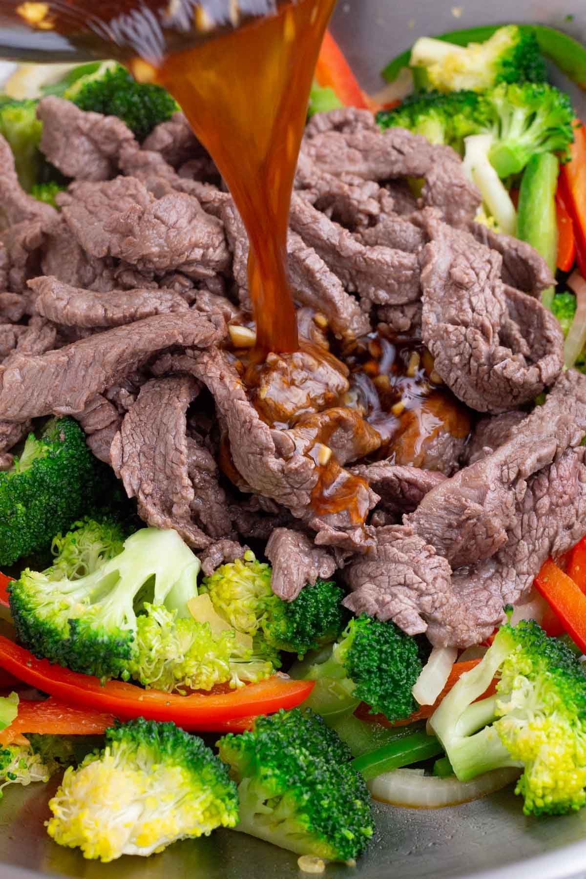 Cooked steak is added back to the veggies and sauce is poured over everything.