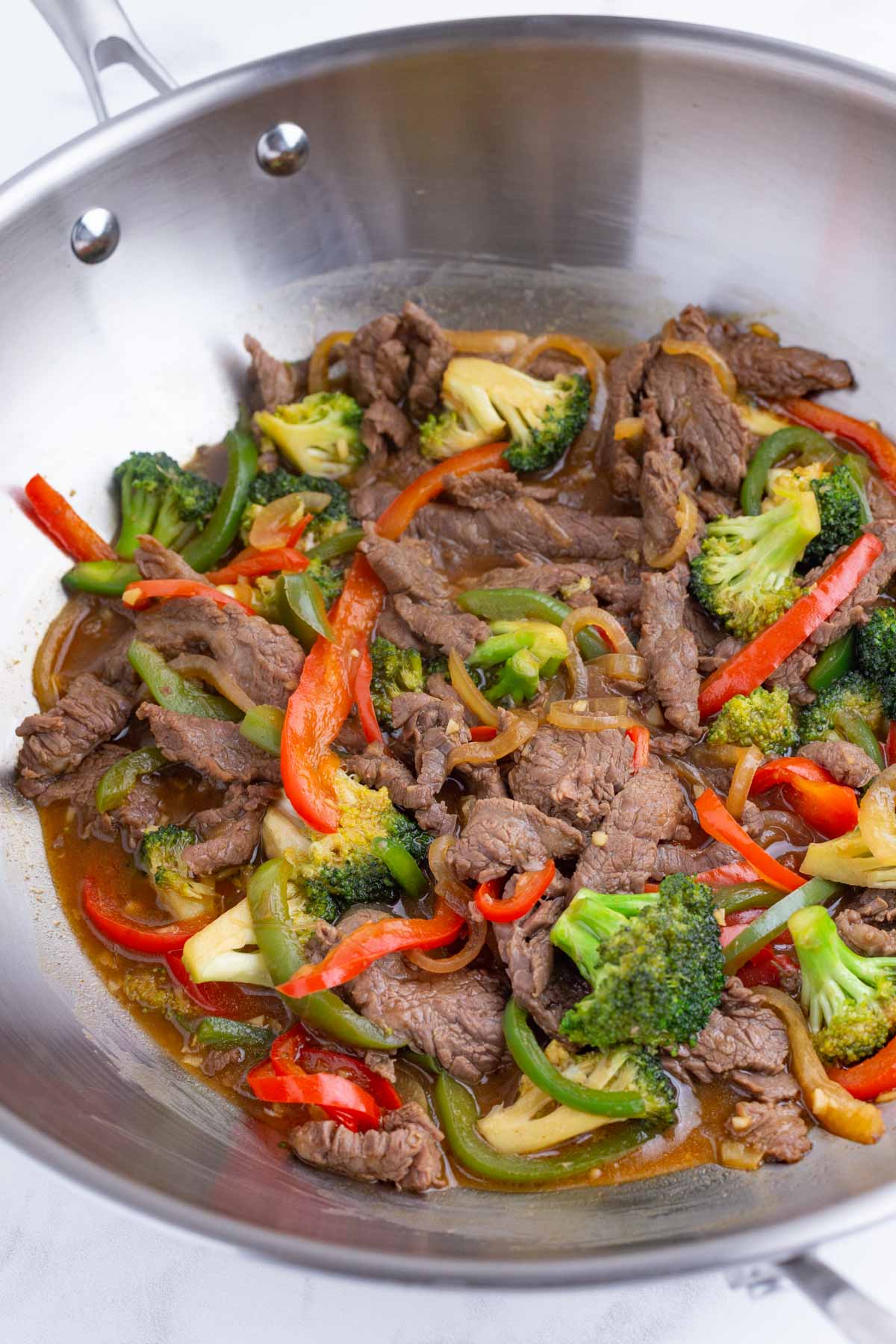 The stir-fry is cooked in a skillet.