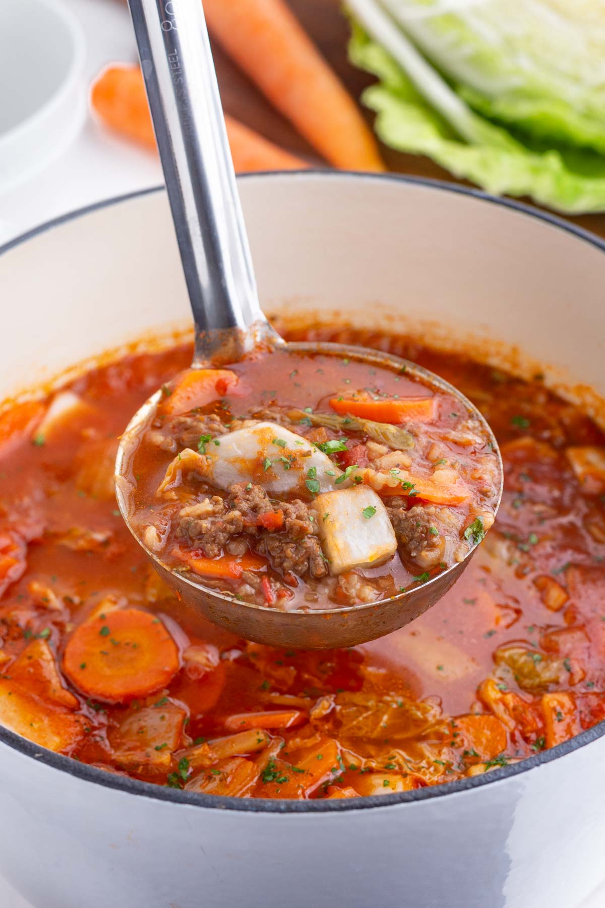 A ladle scoops out cabbage roll soup.