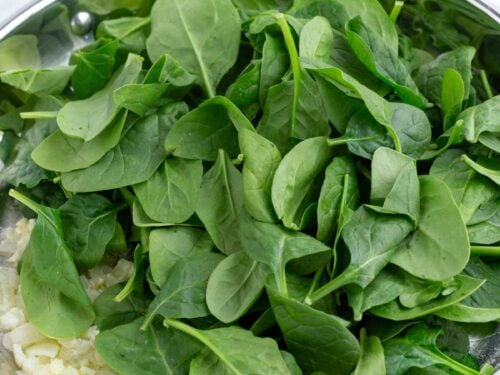 Spinach is added to the skillet.