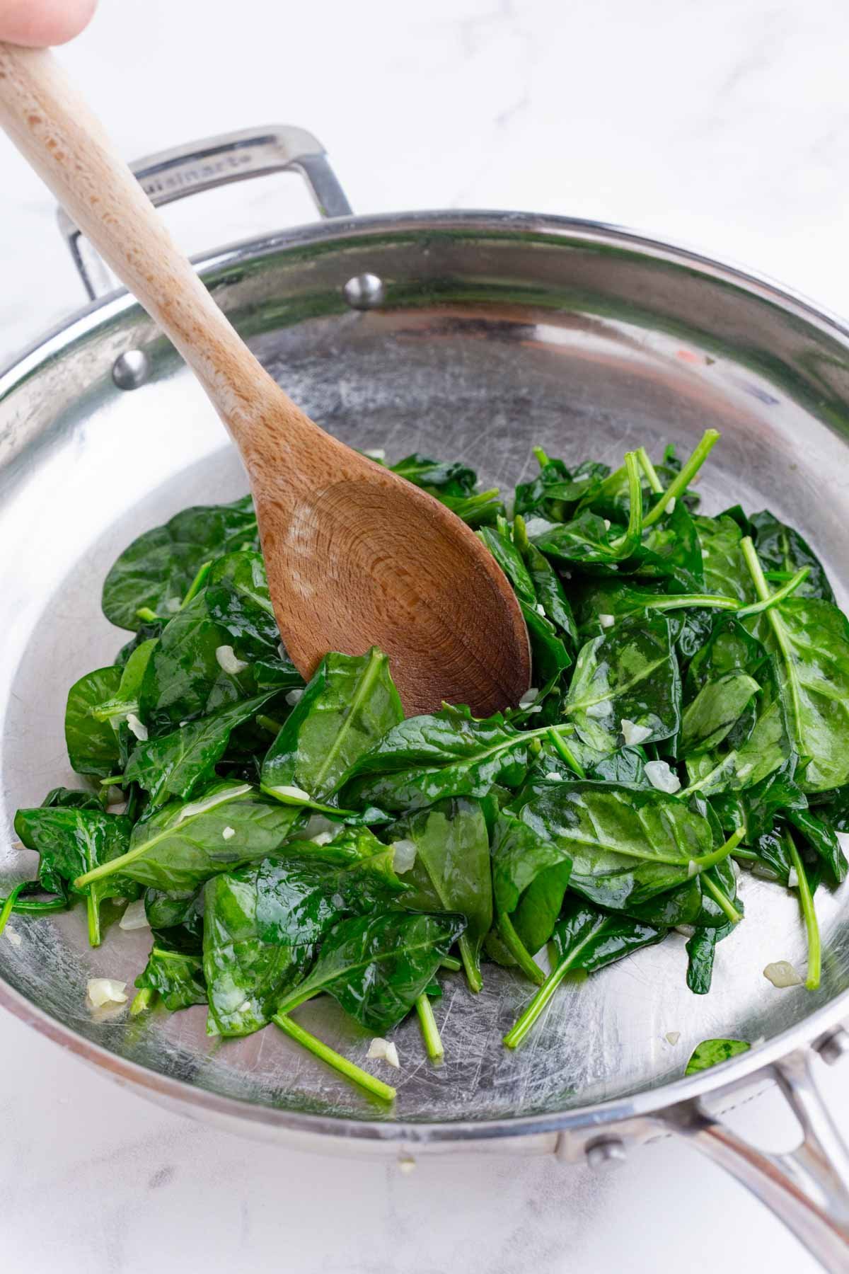 Spinach wilts as it cooks.