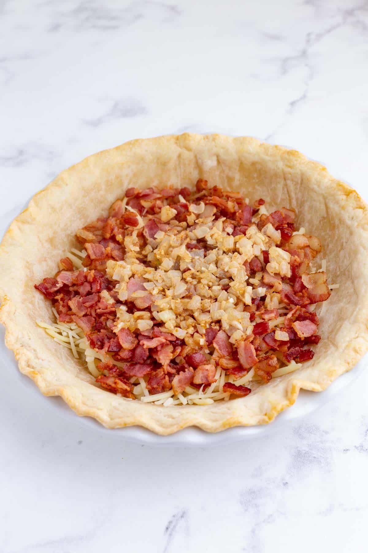 Onions and garlic are added to the pie crust.