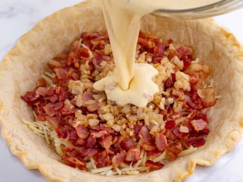 An egg mixture is poured over the fillings.