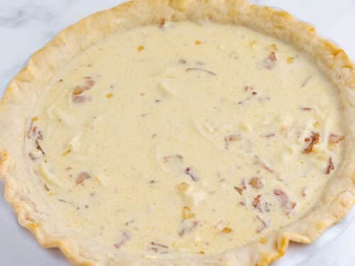 A raw quiche is ready to bake.