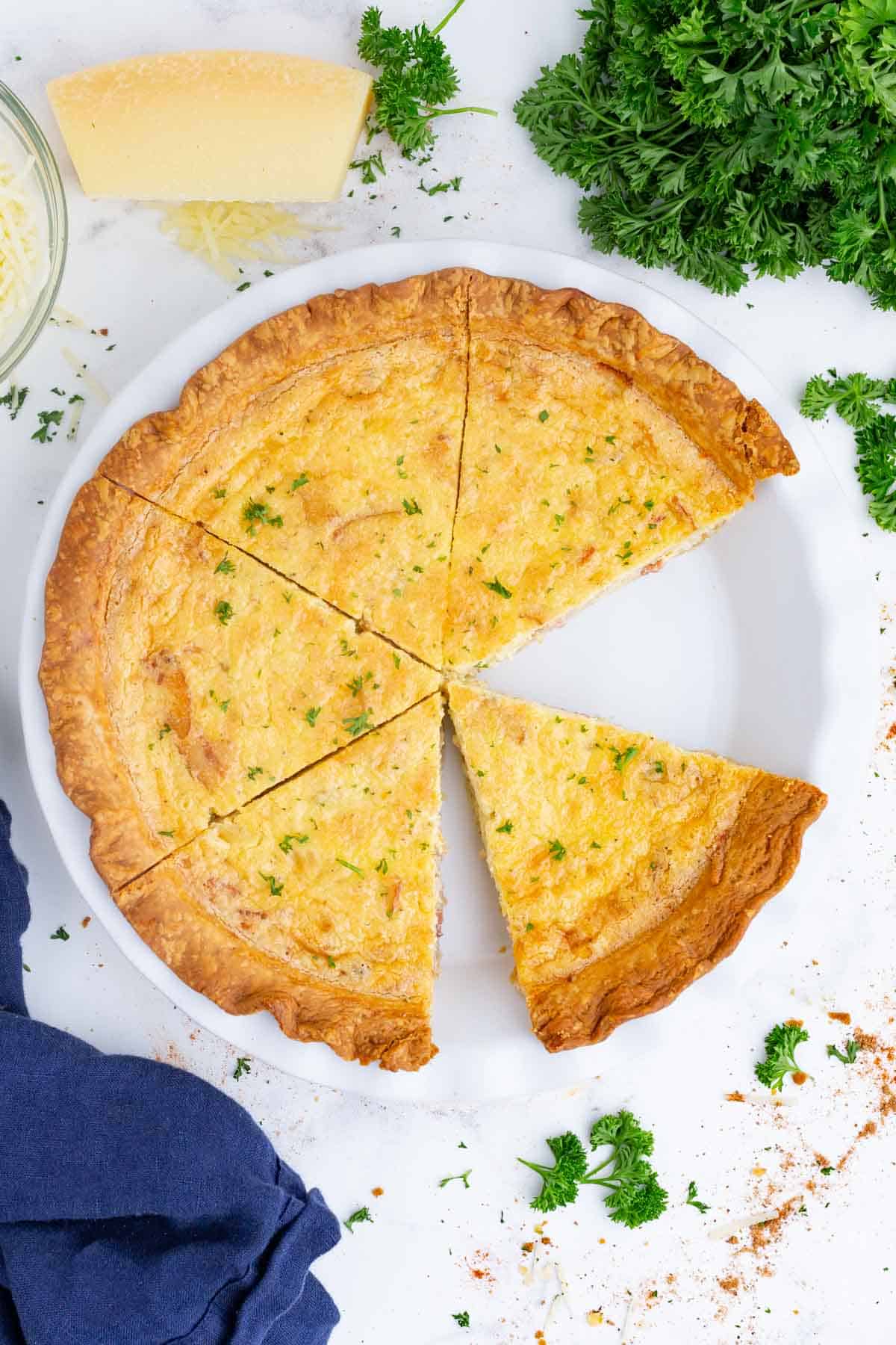 A Quiche Lorraine is sliced before serving.