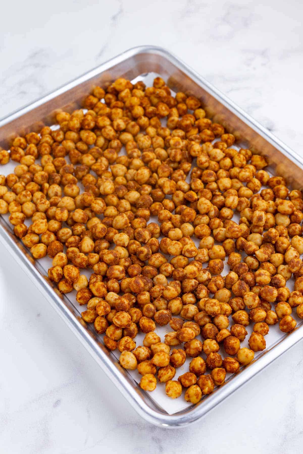 Chickpeas are spread on a pan.