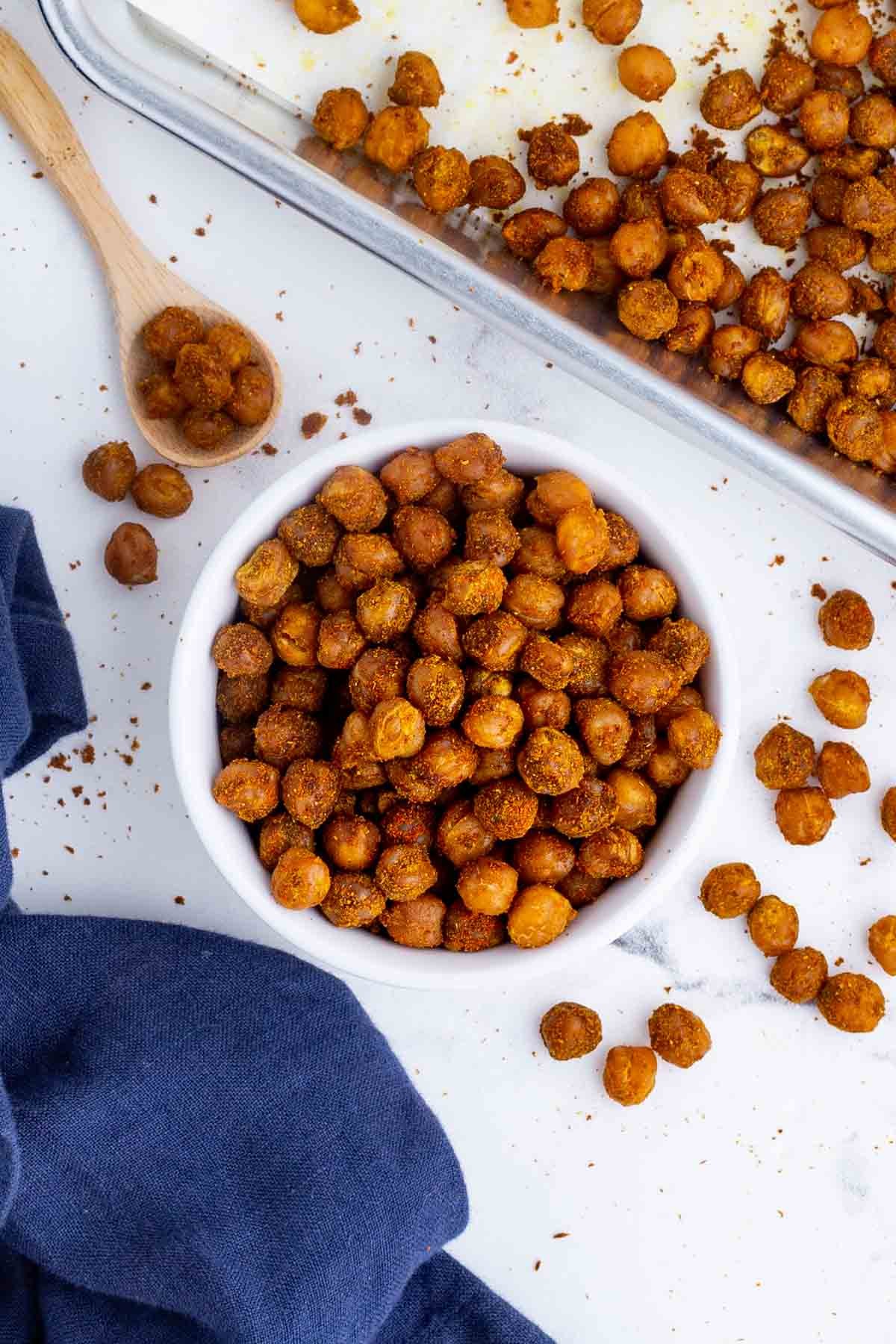 A bowl full of seasoned chickpeas roasted in the oven.