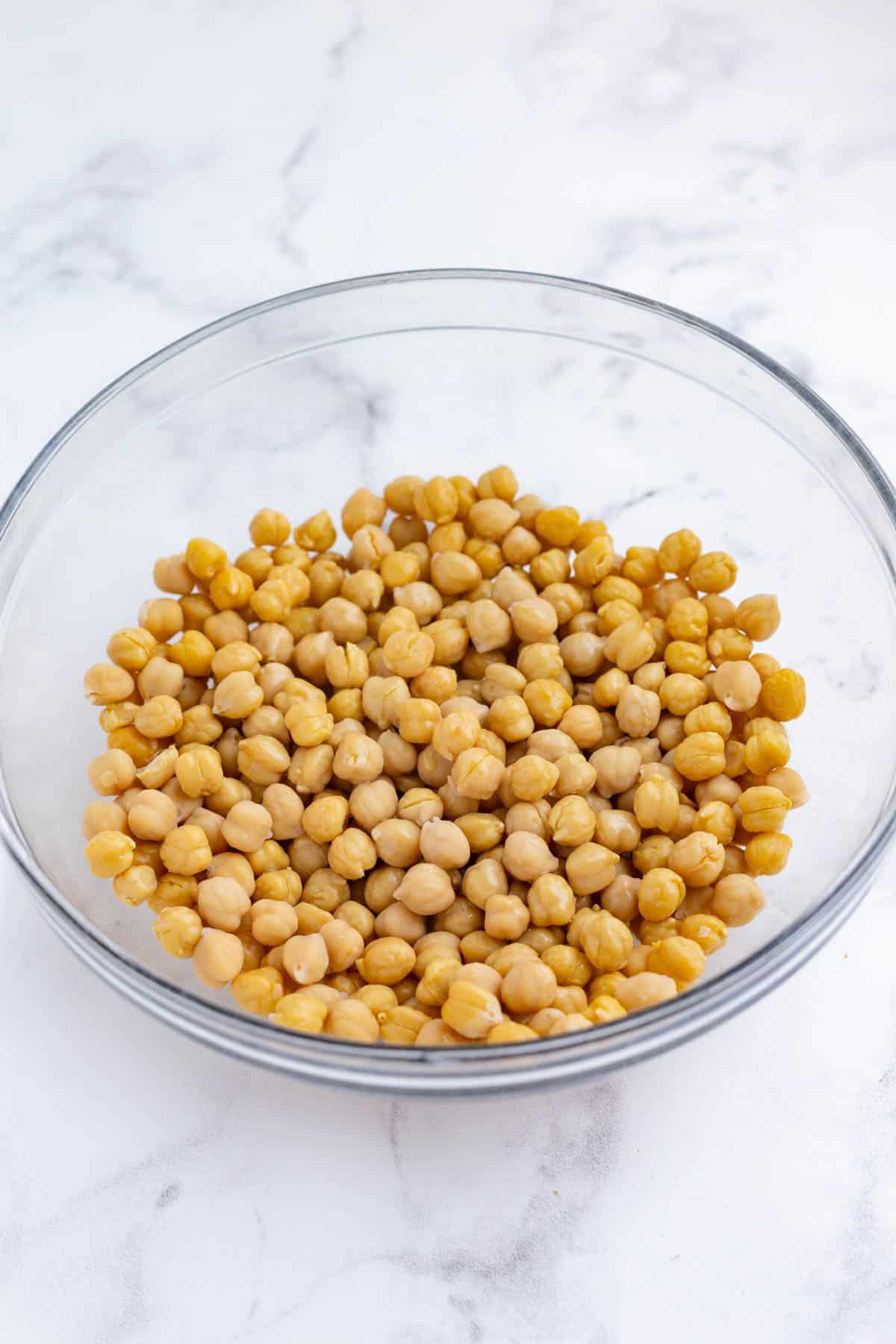 Drizzle olive oil over dried chickpeas.