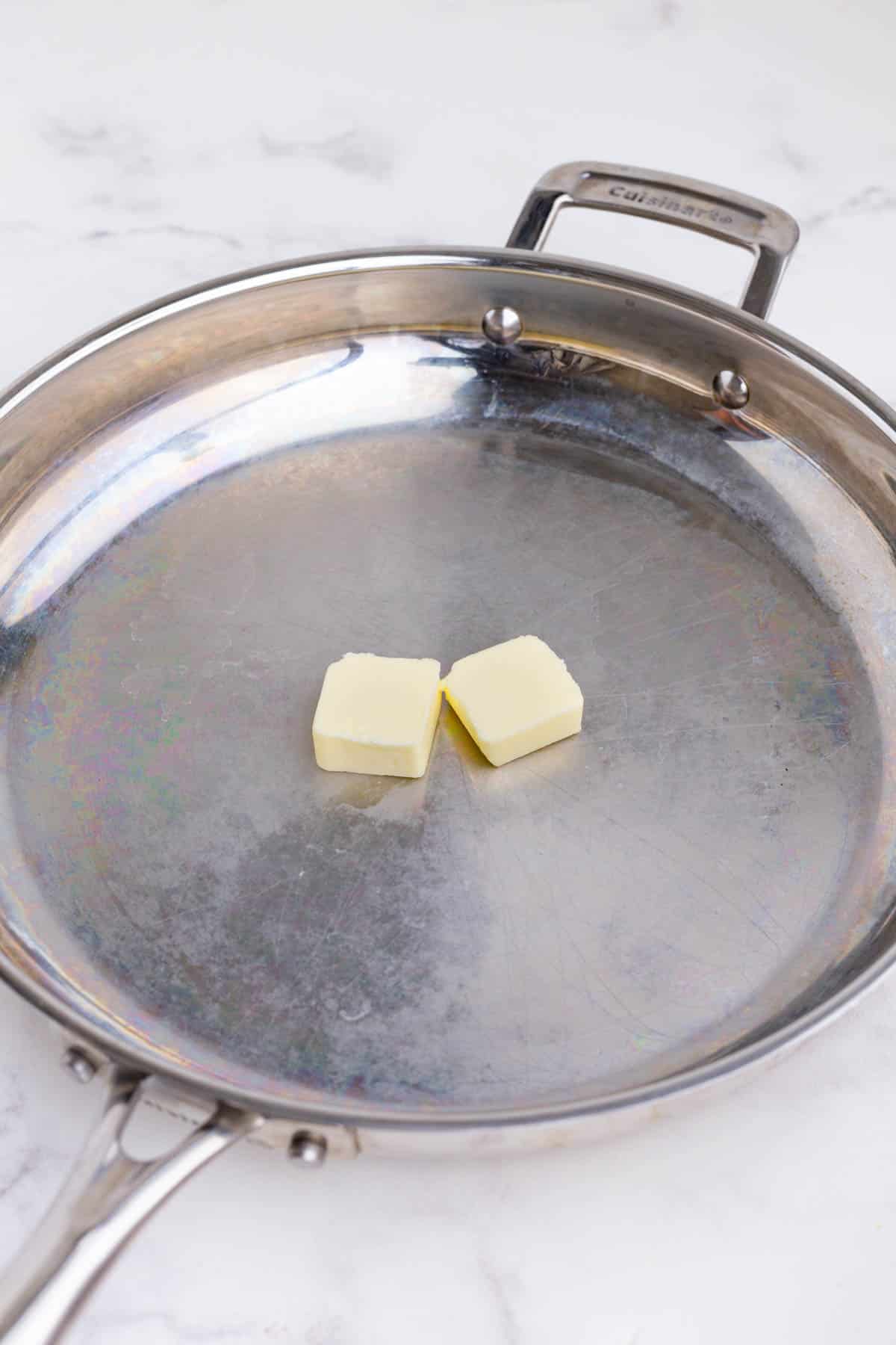 Butter is added to a skillet.