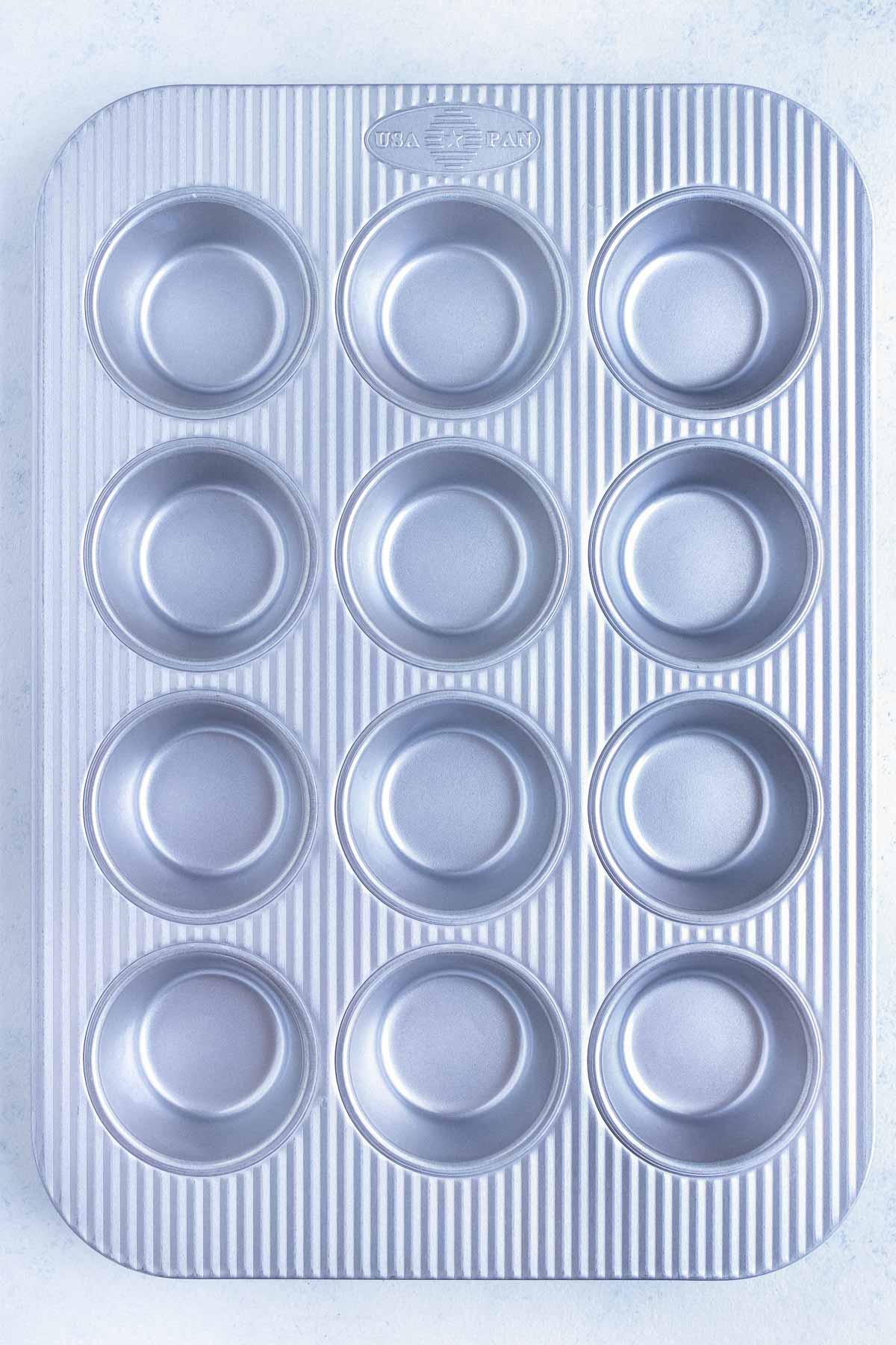 A brand new non-stick muffin tin is shown as the best option for an egg bites recipe.