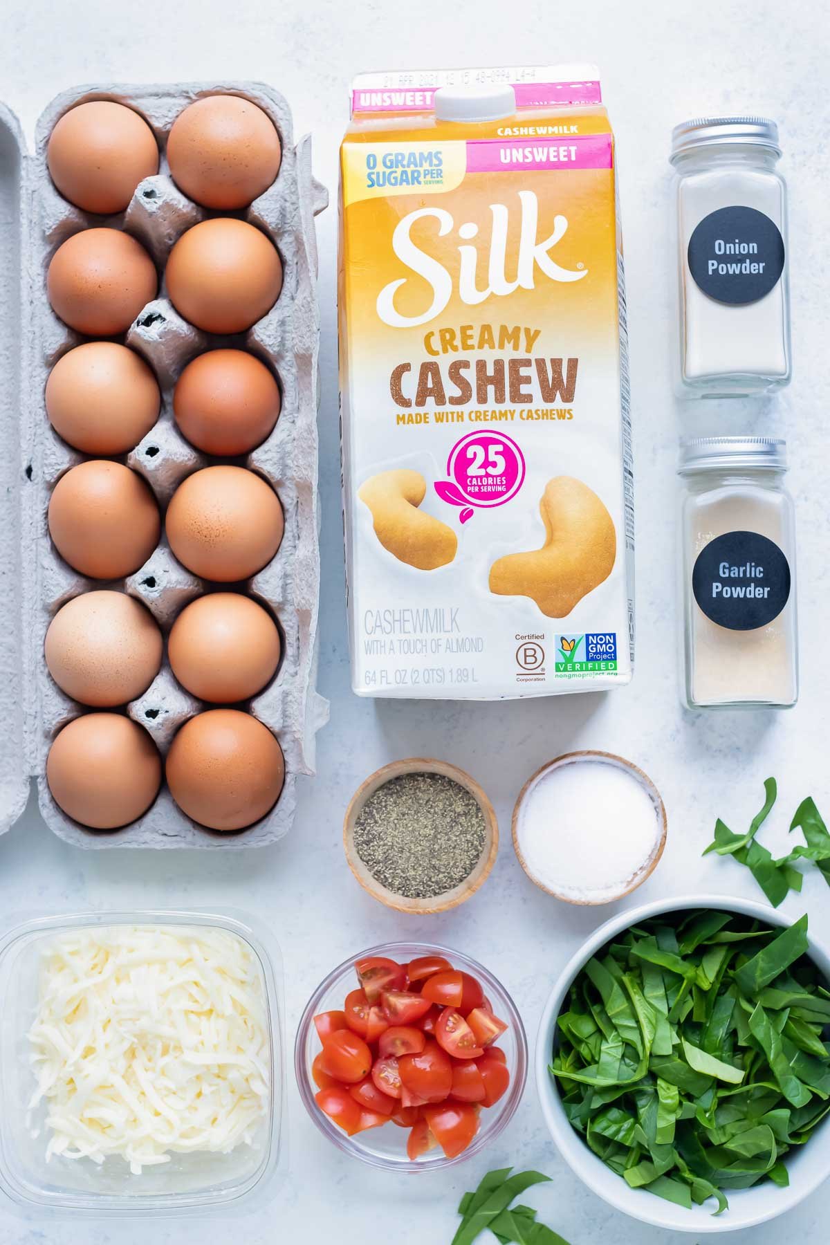 Eggs, milk, spinach, tomatoes, and seasonings are the basic ingredients for this egg muffins recipe.