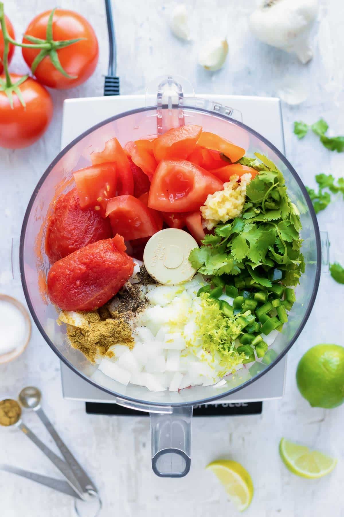 Salsa ingredients are added to a food processor.