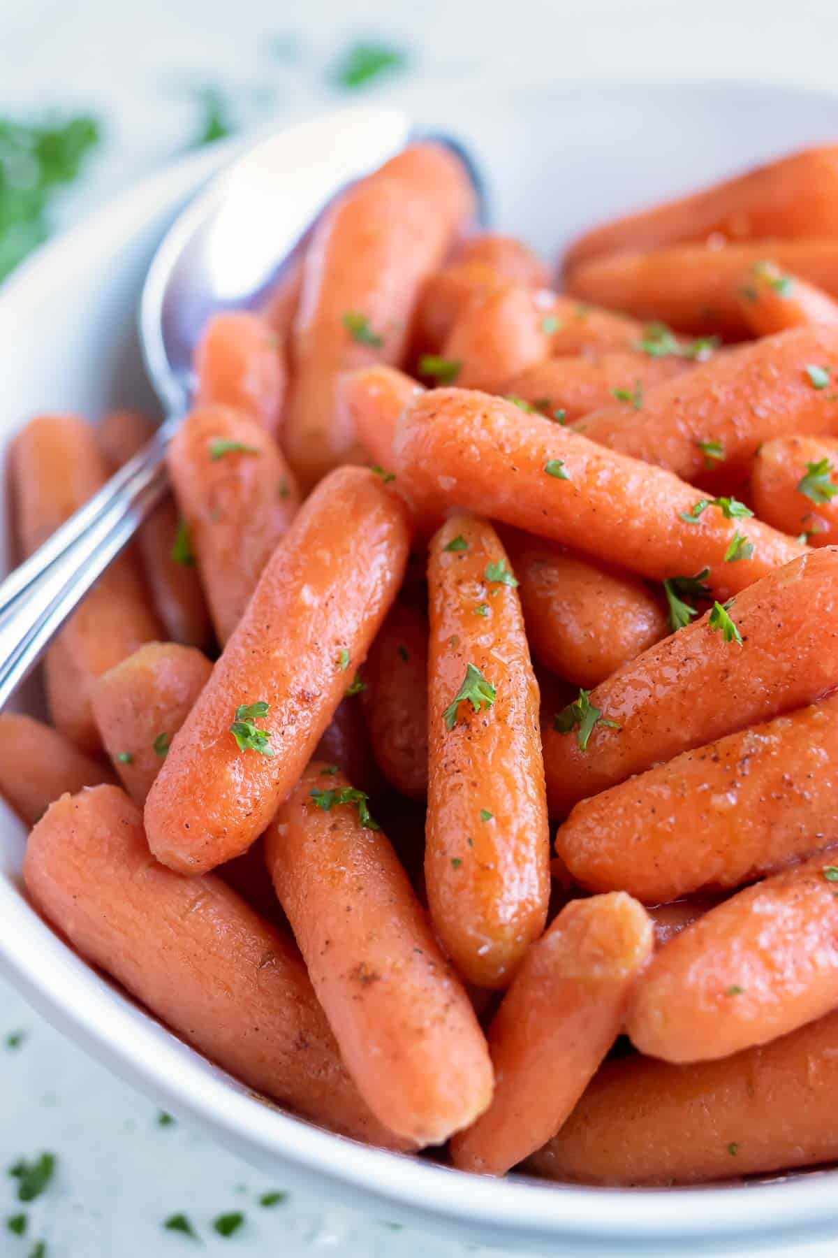 Instant pot carrots are served with a metal spoon.