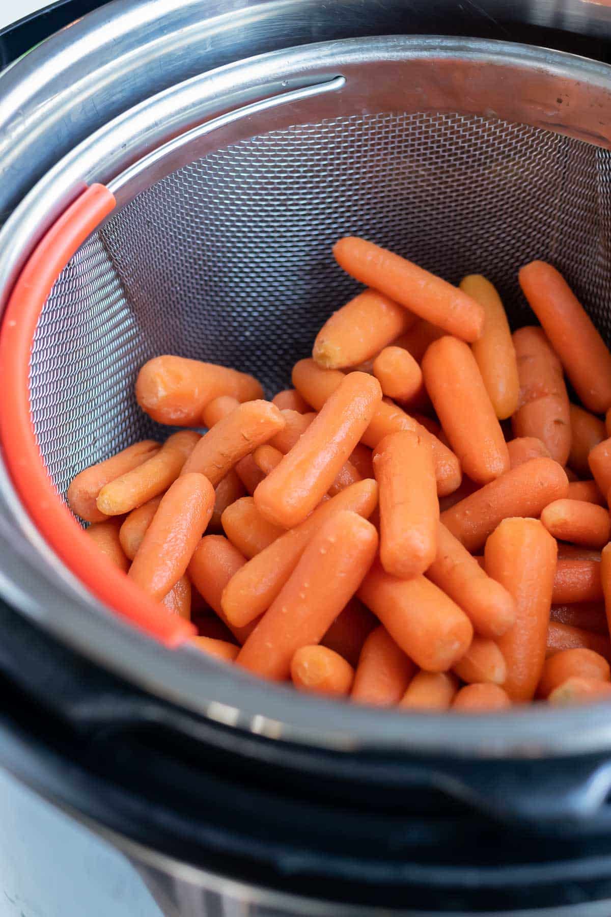 Carrots are placed in the pressure cooker for this recipe.